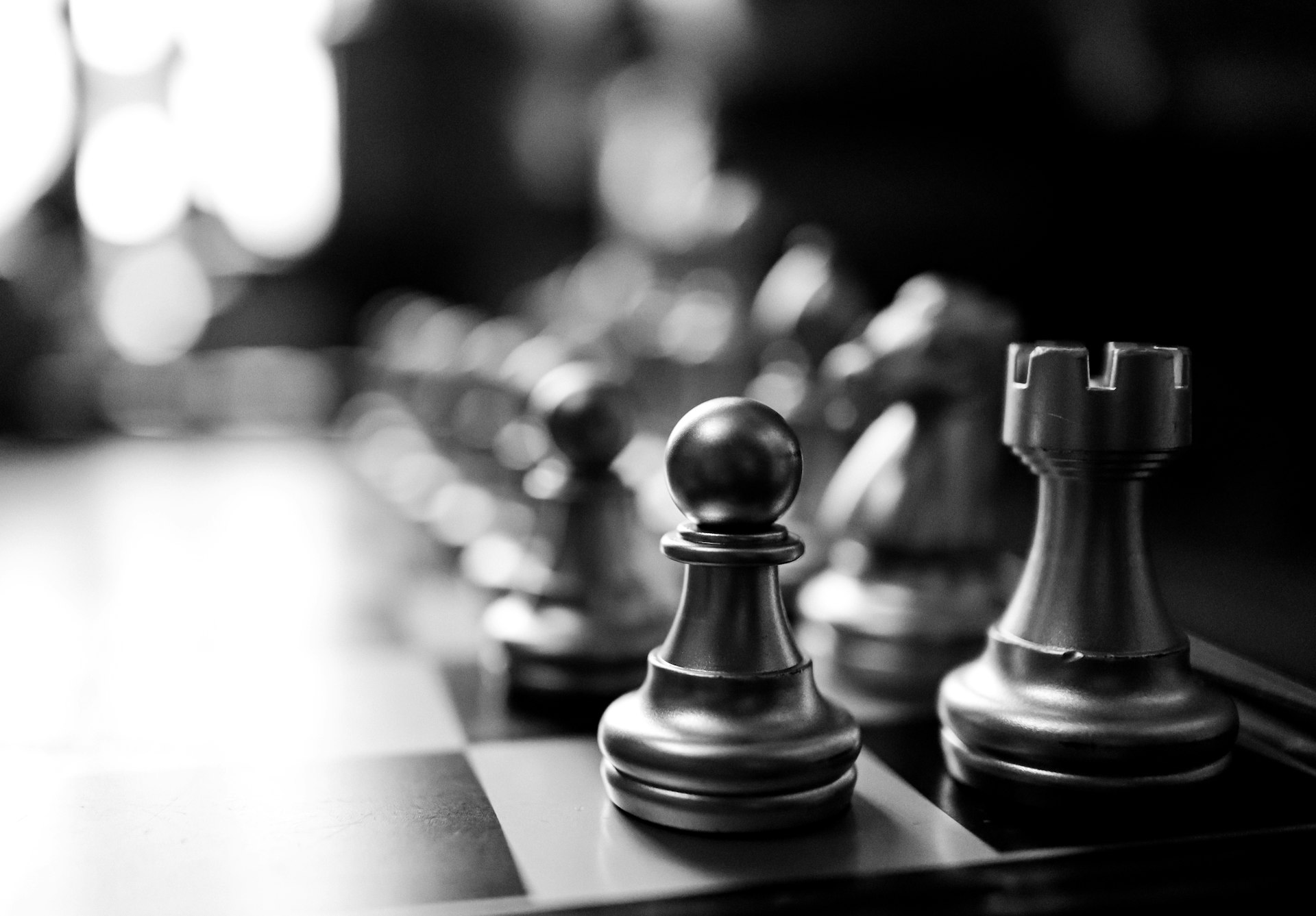 a black and white photo of chess pieces